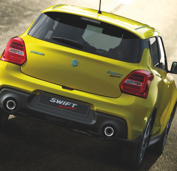 Yellow Swift Sport rear view on road