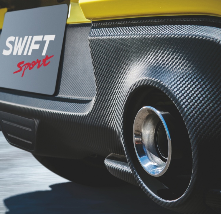 Yellow Swift Sport rear showing logo and sporty exhaust