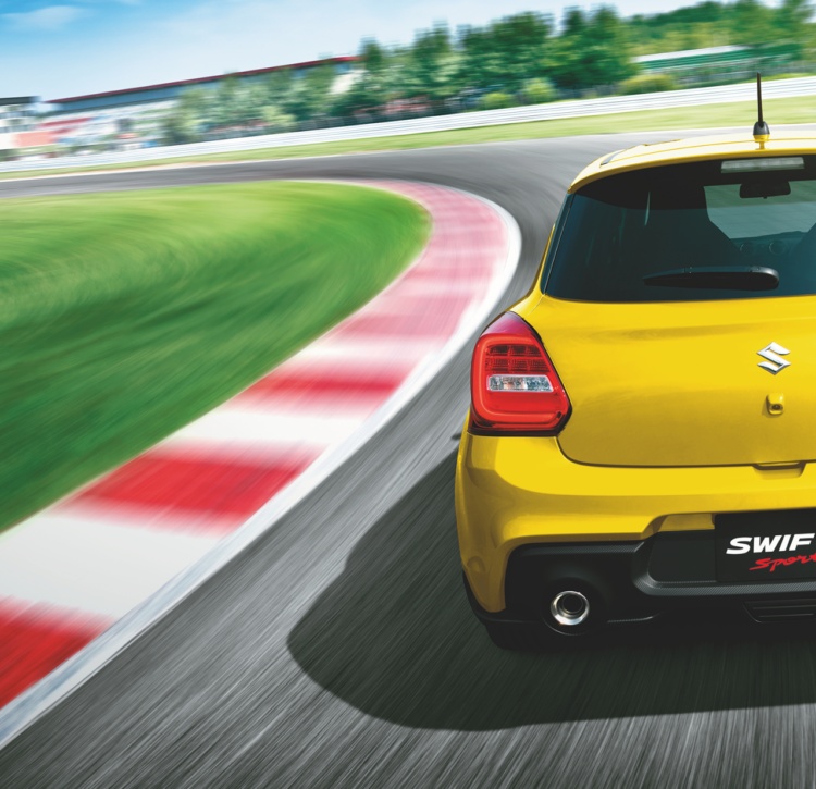 Yellow Swift Sport rear let loose on racetrack