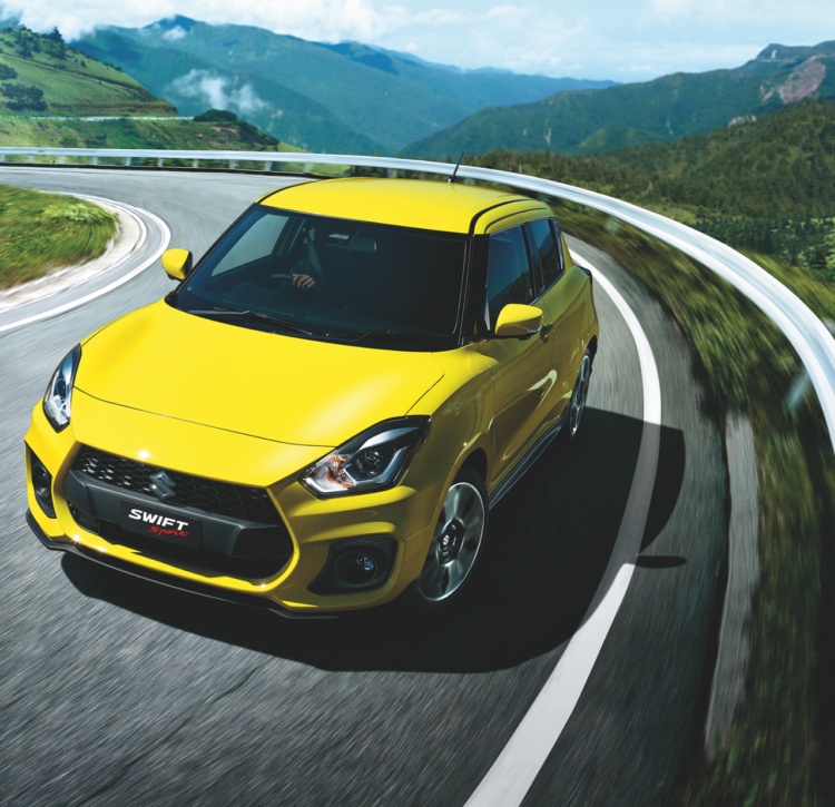 Yellow Swift Sport unleashed on winding mountain roads