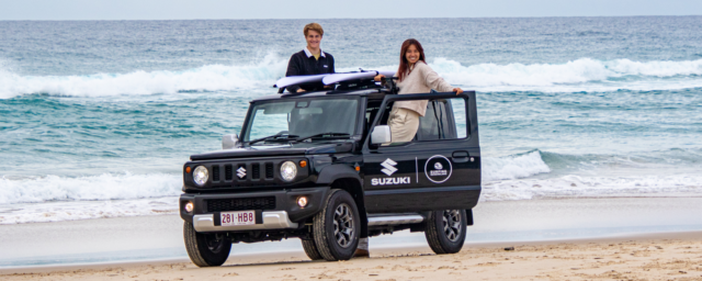 Surfing Queensland ambassadors and Suzuki Jimny parked on the beach