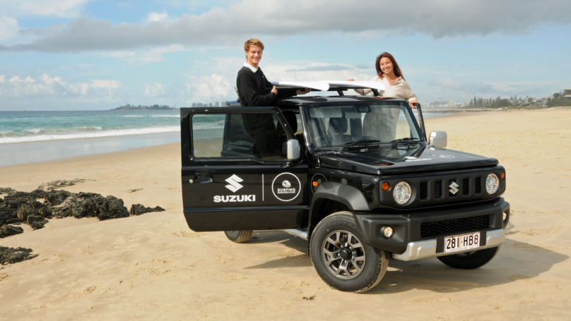 Suzuki Jimny on beach with Surfing Queensland ambassadors