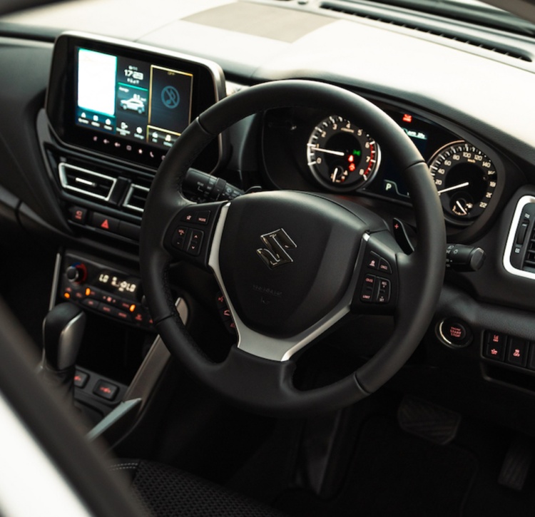Driver's side of Suzuki S-CROSS showing premium steering wheel and audio controls